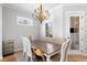 Elegant dining area with hardwood floors, chandelier, and bright lighting perfect for gatherings and Gathering meals at 1010 Fendley St, Woodstock, GA 30188