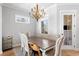 Well-lit dining room with chandelier, wooden table, and views to the living area at 1010 Fendley St, Woodstock, GA 30188