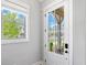 Bright entryway featuring a window view of the porch with chairs and a landscaped yard at 1010 Fendley St, Woodstock, GA 30188