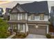 Beautiful two-story home featuring a covered front porch, stone accents, and attached two-car garage at 1010 Fendley St, Woodstock, GA 30188