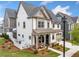 View of a home's exterior highlighting the front porch and professional landscaping at 1010 Fendley St, Woodstock, GA 30188