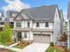 Stylish home featuring a mix of siding and stone accents, plus an attached garage at 1010 Fendley St, Woodstock, GA 30188