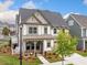 Charming two-story home featuring a welcoming front porch and manicured lawn at 1010 Fendley St, Woodstock, GA 30188