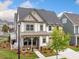 Charming two-story home with a landscaped front yard and inviting front porch with rocking chairs at 1010 Fendley St, Woodstock, GA 30188