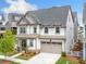 Well-maintained two-story home with a charming front porch and an attached two-car garage at 1010 Fendley St, Woodstock, GA 30188