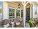 Relaxing front porch with rustic chairs and stone accents at 1010 Fendley St, Woodstock, GA 30188