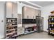 Organized garage featuring ample storage cabinets, shoe racks, and a stainless steel refrigerator for convenience at 1010 Fendley St, Woodstock, GA 30188
