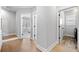 Hallway with hardwood floors leading to the laundry room and bedroom at 1010 Fendley St, Woodstock, GA 30188