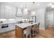 Bright kitchen with white cabinetry, large island, and stainless steel appliances at 1010 Fendley St, Woodstock, GA 30188
