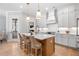Charming kitchen featuring a central island with seating and modern lighting fixtures at 1010 Fendley St, Woodstock, GA 30188