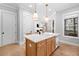 Kitchen island features a sink, white countertop, and stylish pendant lighting at 1010 Fendley St, Woodstock, GA 30188