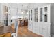 Open-concept kitchen with an island, white cabinetry, and modern appliances at 1010 Fendley St, Woodstock, GA 30188