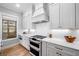 Well-equipped kitchen features stainless steel appliances, white cabinets, and marble countertops at 1010 Fendley St, Woodstock, GA 30188