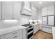 Modern kitchen with white cabinets, tile backsplash, and stainless steel appliances at 1010 Fendley St, Woodstock, GA 30188