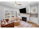 Bright living room with fireplace, large windows, hardwood floors, and comfortable seating creating a welcoming space at 1010 Fendley St, Woodstock, GA 30188