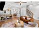 Open floor plan with living room flowing into dining area and kitchen, hardwood floors, and modern decor at 1010 Fendley St, Woodstock, GA 30188