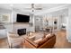 A cozy living room featuring hardwood floors, fireplace, and comfortable seating, seamlessly blending into the dining area at 1010 Fendley St, Woodstock, GA 30188