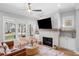 Cozy living room featuring fireplace, large windows offering natural light, and comfortable seating for a relaxing ambiance at 1010 Fendley St, Woodstock, GA 30188