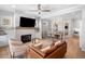 Open-concept living room featuring fireplace, hardwood floors and adjoined dining area at 1010 Fendley St, Woodstock, GA 30188