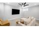 Cozy living room with a large television, comfortable seating, and modern ceiling fan at 1010 Fendley St, Woodstock, GA 30188