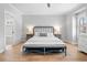 Spacious main bedroom with a king-size bed, hardwood floors, and ample natural light at 1010 Fendley St, Woodstock, GA 30188