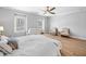 Bright main bedroom featuring hardwood floors, ample natural light, and a cozy seating area at 1010 Fendley St, Woodstock, GA 30188