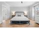 Spacious main bedroom featuring hardwood floors, a decorative bedframe, and soft, natural light at 1010 Fendley St, Woodstock, GA 30188