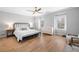 Bright and airy main bedroom features hardwood floors, a ceiling fan, and ample space for relaxation at 1010 Fendley St, Woodstock, GA 30188