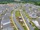 An aerial perspective of a well-planned community with tree-lined streets, playgrounds, and diverse housing styles at 1010 Fendley St, Woodstock, GA 30188