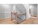 Elegant staircase with wooden handrail and modern black iron balusters, connecting the home's levels at 1010 Fendley St, Woodstock, GA 30188