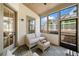 Inviting screened porch features wicker seating, a ceiling fan, and views of the backyard, ideal for relaxation at 1010 Fendley St, Woodstock, GA 30188