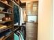 Walk-in closet with custom wood built-in storage, shelving, and hanging racks at 1010 Fendley St, Woodstock, GA 30188