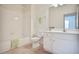 Bright bathroom featuring a tiled tub/shower, white vanity, and a large mirror for a clean and functional space at 2595 Grapevine Cir, Cumming, GA 30041