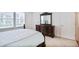 Cozy bedroom featuring a wood dresser, and a window overlooking the outside at 2595 Grapevine Cir, Cumming, GA 30041