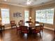 Comfortable dining room with a round table, seating for eight, and natural light from large windows at 2595 Grapevine Cir, Cumming, GA 30041