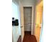 Hallway featuring views of an office and a bathroom with a small linen closet at 2595 Grapevine Cir, Cumming, GA 30041