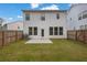 Well-maintained backyard with green lawn, privacy fence, and exterior view of the house at 2789 Aralynn Way, College Park, GA 30337