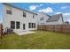 Backyard with lush lawn, privacy fence, and view of the two-story home's rear exterior at 2789 Aralynn Way, College Park, GA 30337