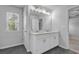 Bright bathroom featuring a double sink vanity, large mirror, and modern lighting at 2789 Aralynn Way, College Park, GA 30337