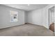 Bedroom with neutral carpet and white walls, featuring a window and access to the en-suite bathroom at 2789 Aralynn Way, College Park, GA 30337