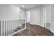 Well-lit hallway featuring wood flooring, access to multiple rooms, and modern railings at 2789 Aralynn Way, College Park, GA 30337