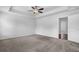 Bright main bedroom with tray ceiling, carpet flooring, and a ceiling fan at 2789 Aralynn Way, College Park, GA 30337
