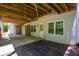 Covered back patio with door, windows, and storage under exposed joists at 3295 Waters Ml, Alpharetta, GA 30022