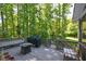 Wood back deck overlooking a tranquil, wooded backyard with outdoor lighting and dining set at 3295 Waters Ml, Alpharetta, GA 30022