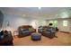 Finished basement features recessed lighting, a stylish ottoman, comfortable seating, and modern flooring at 3295 Waters Ml, Alpharetta, GA 30022