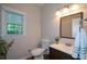 Cozy bathroom featuring wood-look flooring, a stylish vanity, and natural light from the window at 3295 Waters Ml, Alpharetta, GA 30022