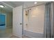 Bathroom with a white tiled shower-tub combo, white door and grey accent curtain at 3295 Waters Ml, Alpharetta, GA 30022