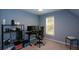 Bedroom with blue walls and a window, furnished with desk setup, shelving, and computer equipment at 3295 Waters Ml, Alpharetta, GA 30022