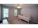 Comfortable bedroom with natural light, plush carpet, area rug, desk and a cozy bed at 3295 Waters Ml, Alpharetta, GA 30022