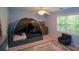 Bedroom featuring tented bed, coordinating dresser, ceiling fan, area rug and natural light from the window at 3295 Waters Ml, Alpharetta, GA 30022